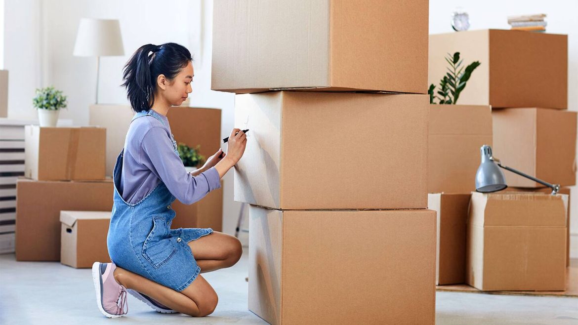 woman-labeling-moving-boxes