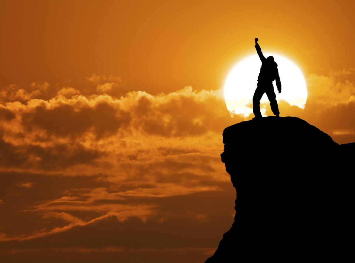 Man on top of mountain How To Truly Inspire Character